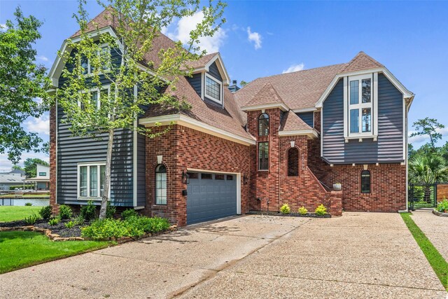 12986 Wood Harbour Dr, Montgomery, TX 77356 - view of front of home with concrete driveway, brick siding, a garage, and a shingled roof