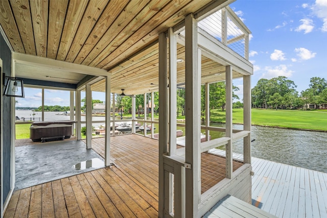 12986 Wood Harbour Dr, Montgomery, TX 77356 - dock area featuring a water view, a hot tub, view of scattered trees, and a lawn