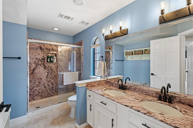 12986 Wood Harbour Dr, Montgomery, TX 77356 - full bath with a shower stall, toilet, double vanity, a textured ceiling, and baseboards