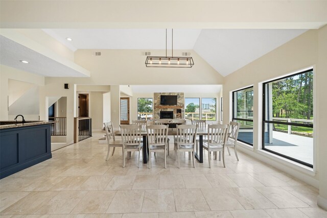 12986 Wood Harbour Dr, Montgomery, TX 77356 - dining room featuring high vaulted ceiling and a stone fireplace