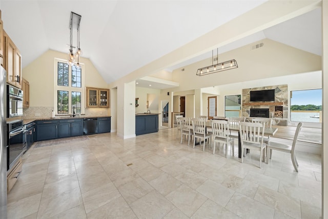 12986 Wood Harbour Dr, Montgomery, TX 77356 - dining room with high vaulted ceiling, plenty of natural light, and a fireplace