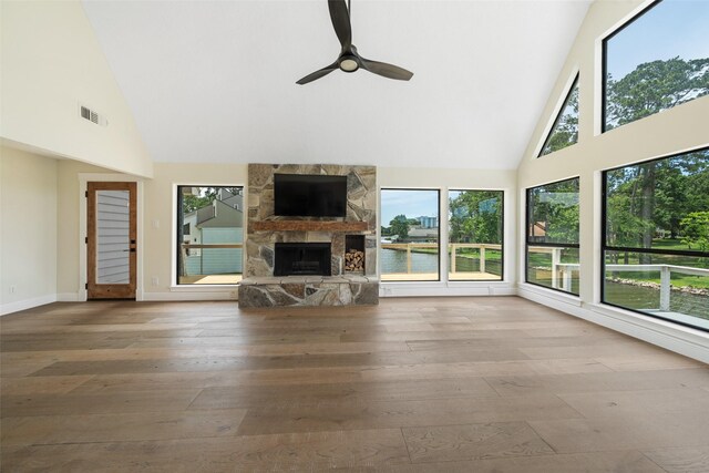 12986 Wood Harbour Dr, Montgomery, TX 77356 - living area with high vaulted ceiling, wood-type flooring, plenty of natural light, a ceiling fan, and a fireplace
