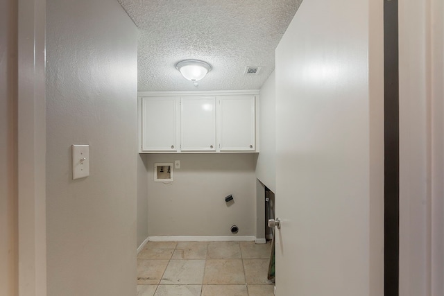 19523 Enchanted Grove Dr, Spring, TX 77388 - washroom featuring hookup for an electric dryer, a textured ceiling, cabinet space, hookup for a washing machine, and baseboards
