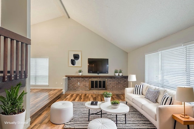 19523 Enchanted Grove Dr, Spring, TX 77388 - living room with wood finished floors, beamed ceiling, high vaulted ceiling, and baseboards