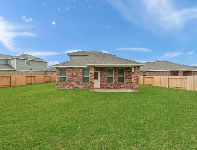 5602 Tabula Rasa Dr, Katy, TX 77493 - back of house featuring a shingled roof, a patio area, and brick siding