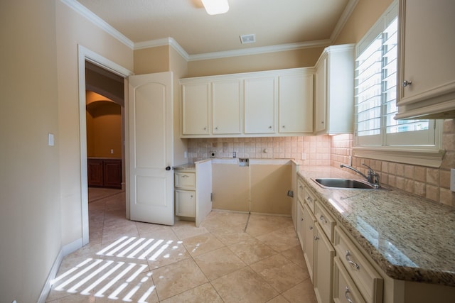 17715 Badtke Rd, Hockley, TX 77447 - kitchen with a sink, tasteful backsplash, arched walkways, light stone countertops, and ornamental molding