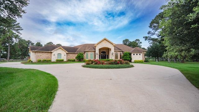 17715 Badtke Rd, Hockley, TX 77447 - view of front facade featuring curved driveway and stone siding