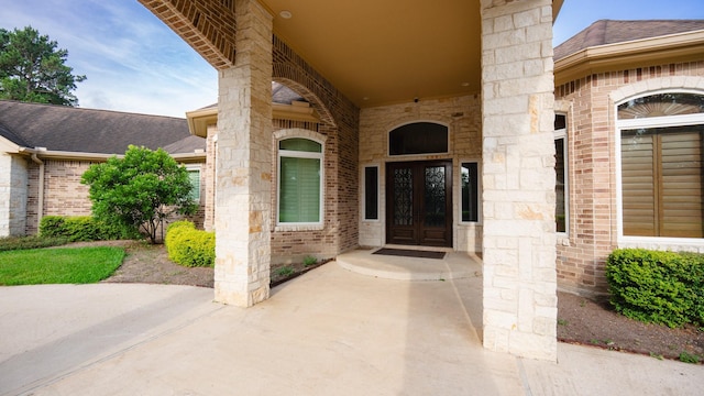 17715 Badtke Rd, Hockley, TX 77447 - property entrance featuring brick siding, french doors, a shingled roof, and stone siding
