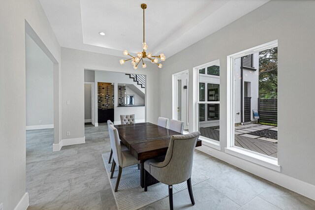 12914 Figaro Dr, Houston, TX 77024 - dining area with a chandelier, baseboards, stairs, and a tray ceiling