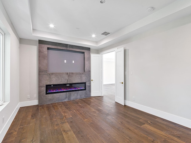 12914 Figaro Dr, Houston, TX 77024 - unfurnished living room with wood-type flooring, baseboards, a fireplace, a raised ceiling, and recessed lighting