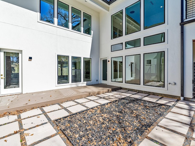 12914 Figaro Dr, Houston, TX 77024 - rear view of property with stucco siding, a deck, and a patio
