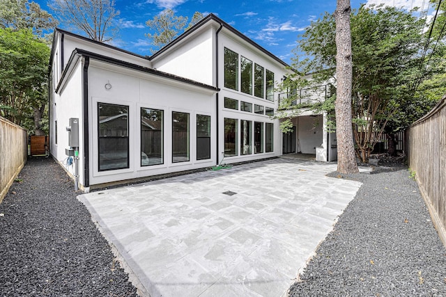 12914 Figaro Dr, Houston, TX 77024 - rear view of house featuring stucco siding, a fenced backyard, and a patio
