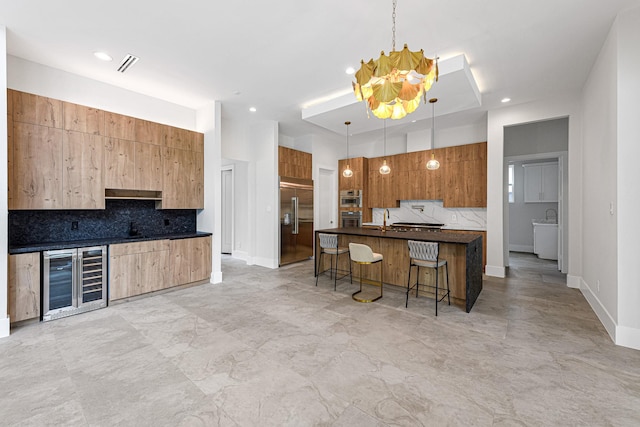 12914 Figaro Dr, Houston, TX 77024 - kitchen featuring wine cooler, built in fridge, decorative backsplash, a kitchen bar, and dark countertops