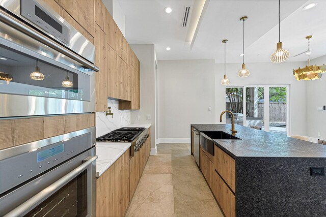 12914 Figaro Dr, Houston, TX 77024 - kitchen with modern cabinets, a sink, stainless steel appliances, recessed lighting, and pendant lighting