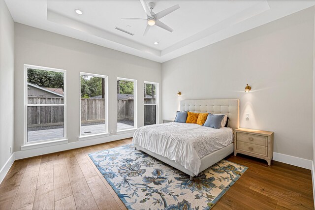 12914 Figaro Dr, Houston, TX 77024 - bedroom with a raised ceiling, hardwood / wood-style flooring, baseboards, recessed lighting, and ceiling fan