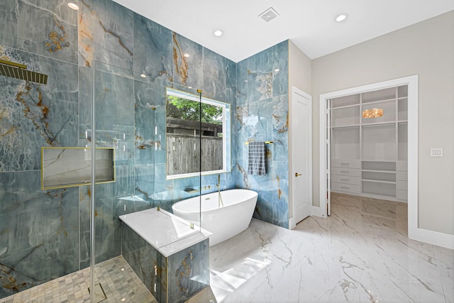 12914 Figaro Dr, Houston, TX 77024 - bathroom featuring a freestanding bath, a marble finish shower, a walk in closet, marble tiled flooring, and recessed lighting