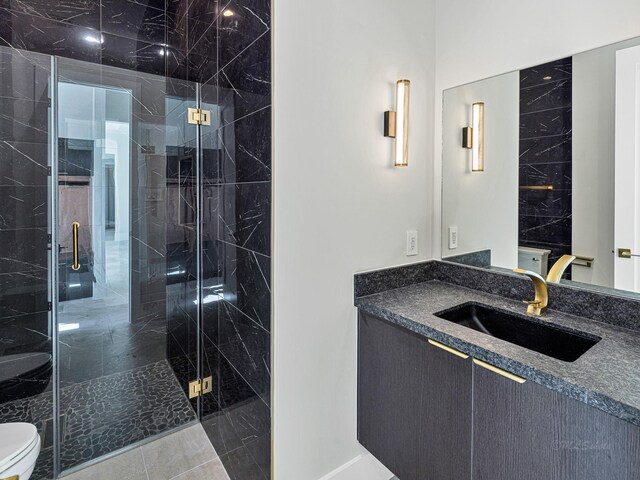12914 Figaro Dr, Houston, TX 77024 - bathroom with toilet, vanity, and a marble finish shower