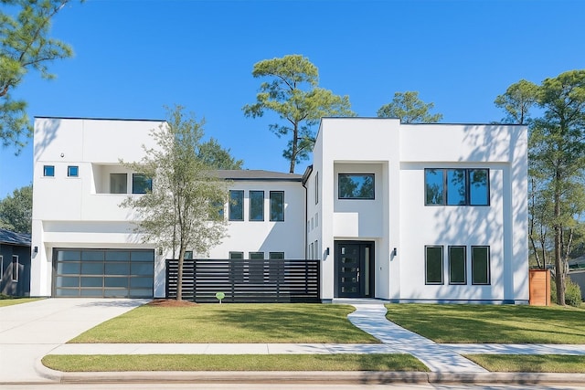 12914 Figaro Dr, Houston, TX 77024 - contemporary home featuring stucco siding, an attached garage, and concrete driveway