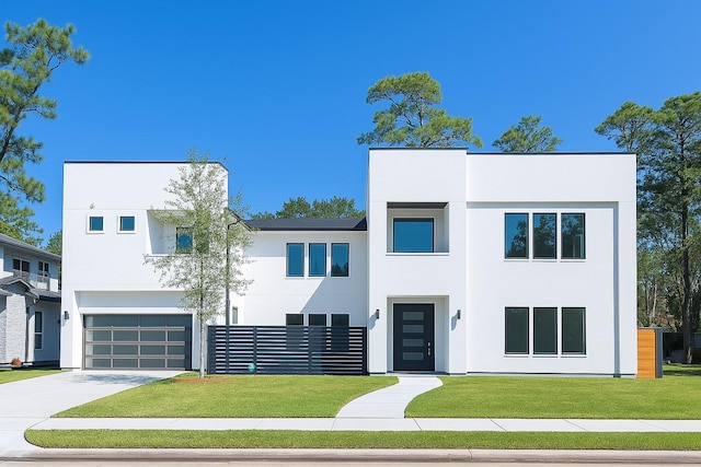 12914 Figaro Dr, Houston, TX 77024 - contemporary house featuring stucco siding, concrete driveway, a garage, and a front yard