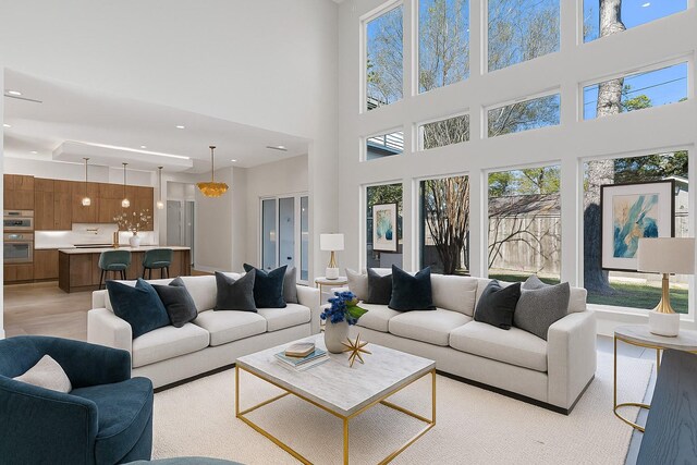 12914 Figaro Dr, Houston, TX 77024 - living room with a towering ceiling, healthy amount of natural light, recessed lighting, and light wood finished floors