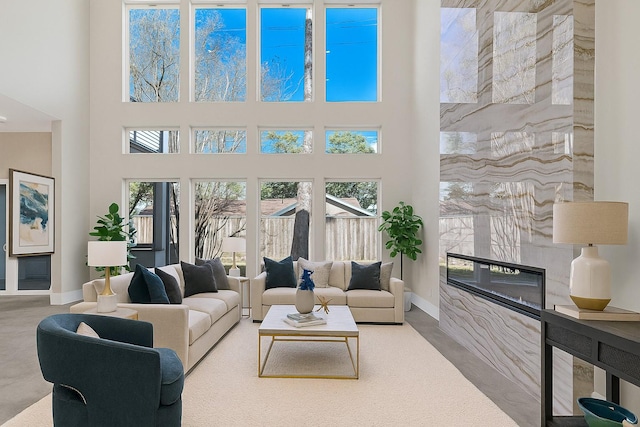 12914 Figaro Dr, Houston, TX 77024 - carpeted living room with a high end fireplace and a high ceiling