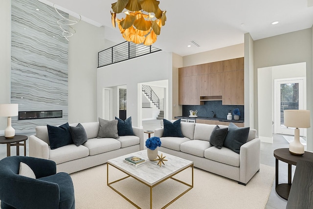 12914 Figaro Dr, Houston, TX 77024 - living room with stairway, a towering ceiling, and recessed lighting