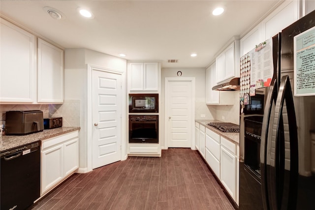 18226 Golden Falls Ln, Spring, TX 77379 - kitchen with black appliances, under cabinet range hood, white cabinets, dark wood finished floors, and recessed lighting