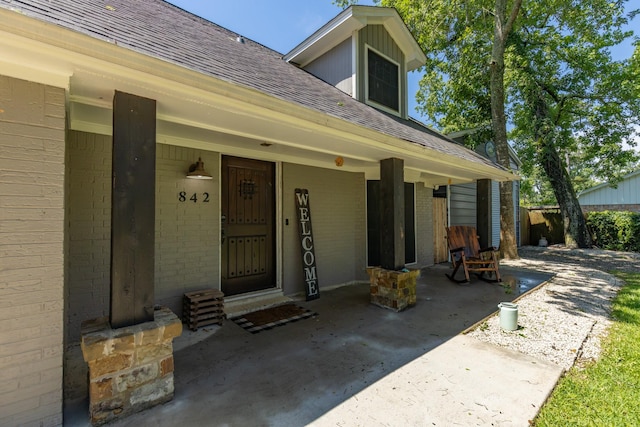 842 Broad Ripple Dr, Houston, TX 77336 - doorway to property with roof with shingles, brick siding, and covered porch