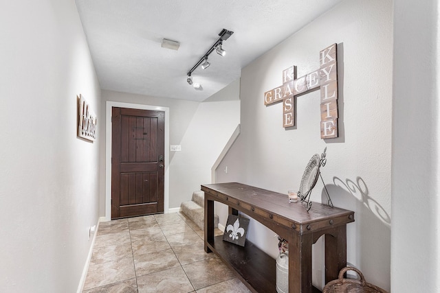 842 Broad Ripple Dr, Houston, TX 77336 - foyer featuring stairway, baseboards, and track lighting