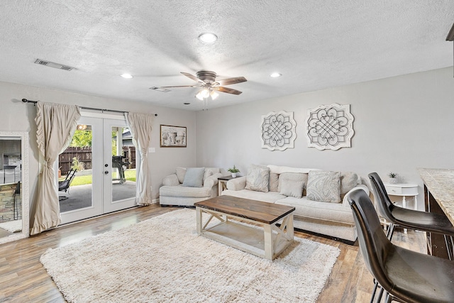 842 Broad Ripple Dr, Houston, TX 77336 - living area featuring french doors, a textured ceiling, light wood-style floors, ceiling fan, and recessed lighting