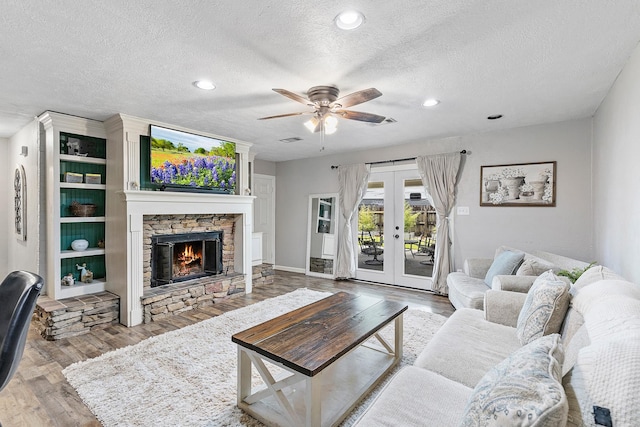 842 Broad Ripple Dr, Houston, TX 77336 - living room featuring ceiling fan, a textured ceiling, wood finished floors, french doors, and recessed lighting