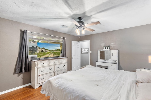 842 Broad Ripple Dr, Houston, TX 77336 - bedroom with light wood finished floors, baseboards, and a ceiling fan