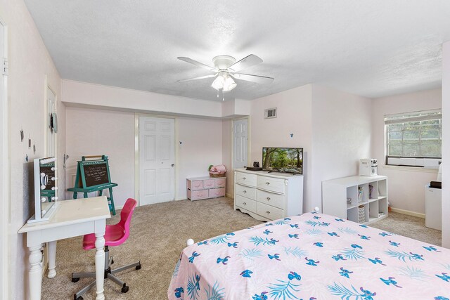 842 Broad Ripple Dr, Houston, TX 77336 - bedroom with light colored carpet, a closet, a textured ceiling, and a ceiling fan