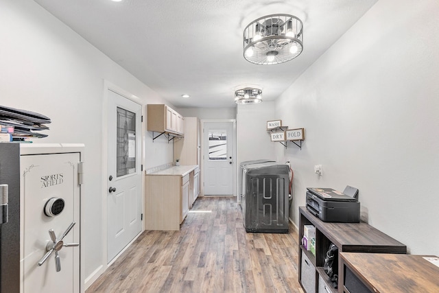 842 Broad Ripple Dr, Houston, TX 77336 - kitchen featuring light wood finished floors, light countertops, baseboards, and a chandelier
