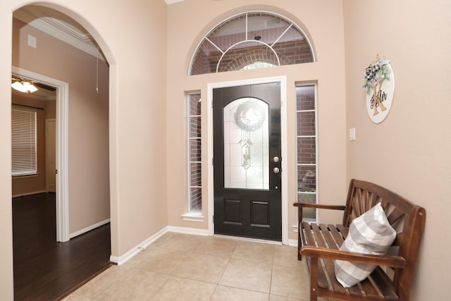 18123 Quarry Vale Dr, Cypress, TX 77429 - entrance foyer featuring baseboards, arched walkways, and light tile patterned floors