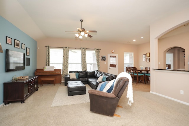 18123 Quarry Vale Dr, Cypress, TX 77429 - living area featuring ceiling fan, light carpet, baseboards, arched walkways, and vaulted ceiling