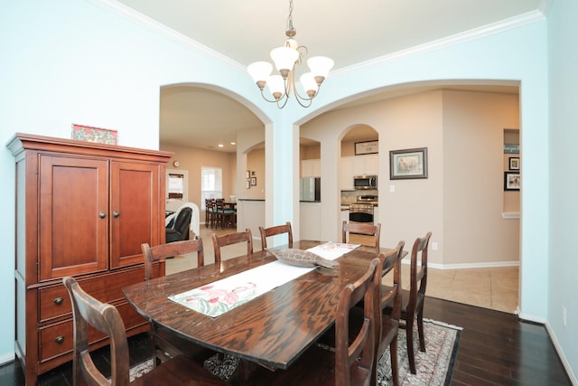 18123 Quarry Vale Dr, Cypress, TX 77429 - dining room featuring arched walkways, crown molding, a chandelier, dark wood-style flooring, and baseboards