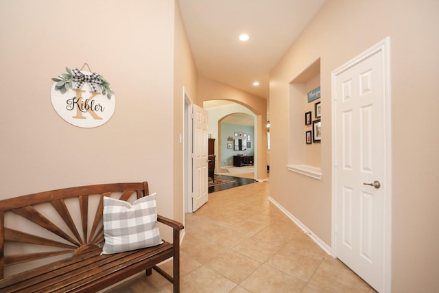 18123 Quarry Vale Dr, Cypress, TX 77429 - hallway with arched walkways, light tile patterned floors, recessed lighting, and baseboards