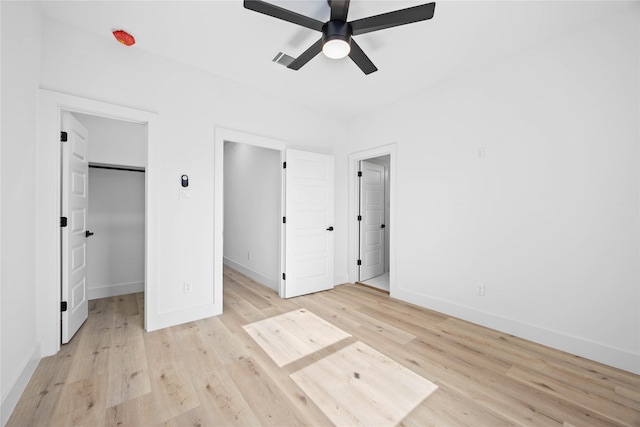 2206 Bleker St, Houston, TX 77026 - unfurnished bedroom with baseboards, light wood finished floors, a spacious closet, and a ceiling fan