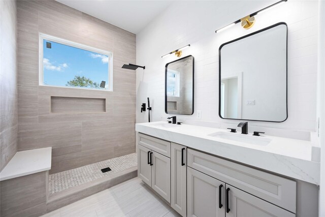 2206 Bleker St, Houston, TX 77026 - bathroom featuring a tile shower, double vanity, healthy amount of natural light, and tile patterned flooring