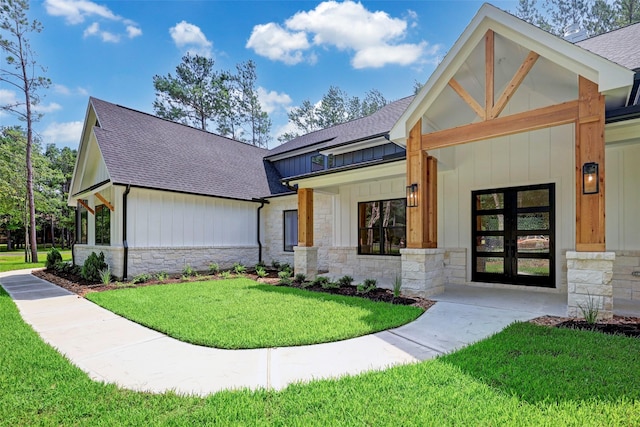 688 Lonestar Rd, Huntsville, TX 77340 - view of front facade with stone siding, roof with shingles, and board and batten siding