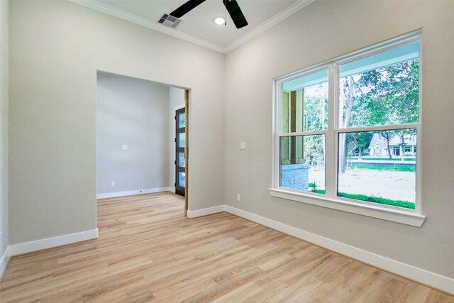 688 Lonestar Rd, Huntsville, TX 77340 - spare room with ornamental molding, healthy amount of natural light, a ceiling fan, baseboards, and light wood-style flooring