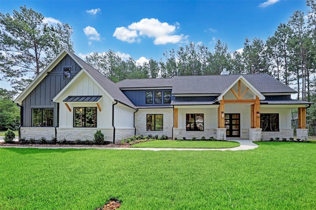688 Lonestar Rd, Huntsville, TX 77340 - modern farmhouse featuring stone siding, french doors, a front yard, board and batten siding, and roof with shingles