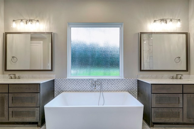688 Lonestar Rd, Huntsville, TX 77340 - full bathroom featuring plenty of natural light, two vanities, and a freestanding bath