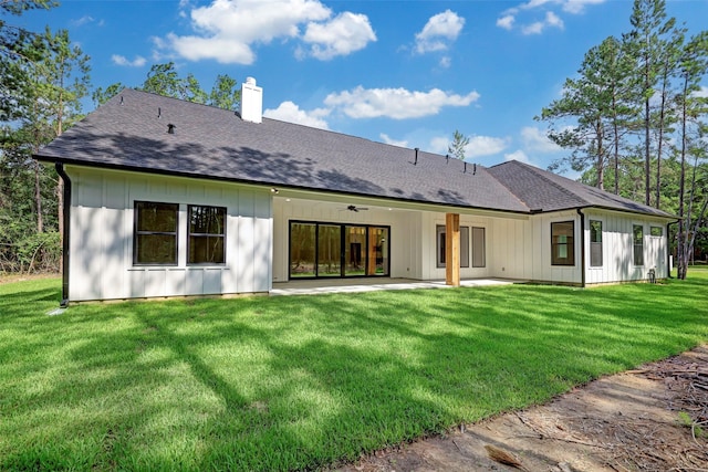 688 Lonestar Rd, Huntsville, TX 77340 - back of house with a chimney, a patio, a yard, and board and batten siding