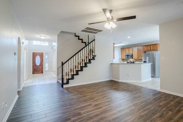 16511 Bluefin St, Crosby, TX 77532 - foyer with wood finished floors, stairway, arched walkways, a ceiling fan, and recessed lighting
