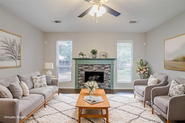 16511 Bluefin St, Crosby, TX 77532 - living area with a ceiling fan, wood finished floors, and a stone fireplace