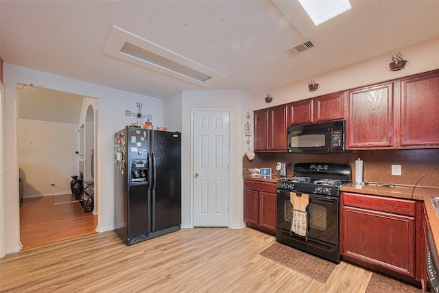 1810 Macondray Dr, Humble, TX 77396 - kitchen with black appliances, light wood-style floors, baseboards, and light countertops
