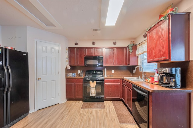 1810 Macondray Dr, Humble, TX 77396 - kitchen featuring black appliances, a sink, light wood-style flooring, and light countertops