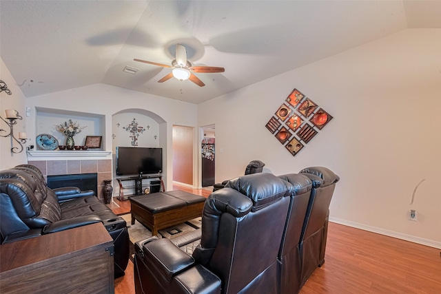 1810 Macondray Dr, Humble, TX 77396 - living room with lofted ceiling, ceiling fan, a tile fireplace, light wood-style floors, and baseboards